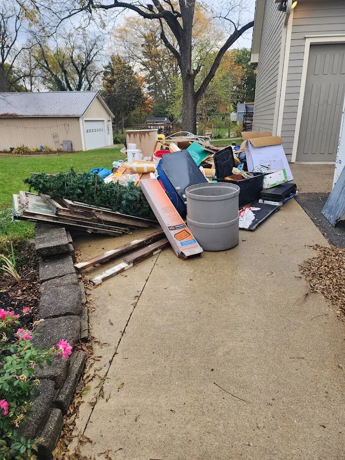 Dumpster being loaded with debris for Roofing Dumpster Rental in Bensenville